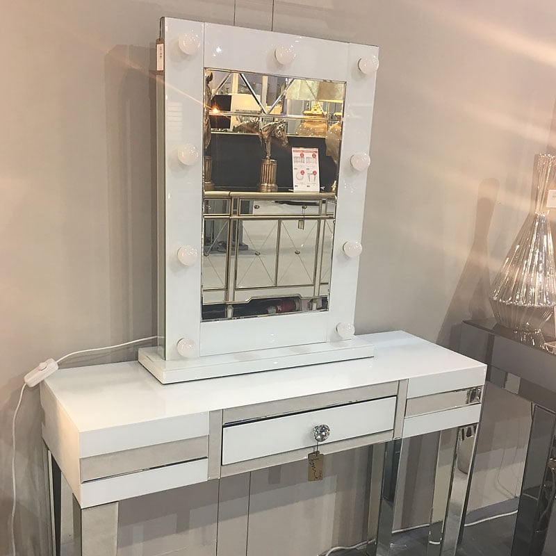 white vanity with mirror and lights