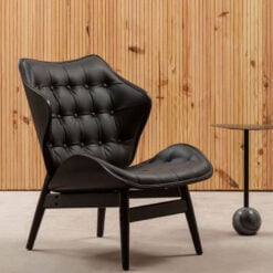 Mid Century Black Faux Leather And Black Wood Tufted Winged Accent Chair With A Curved Seat Mid Century Black Faux Leather And Black Wood Tufted Winged Accent Chair With A Curved Seat